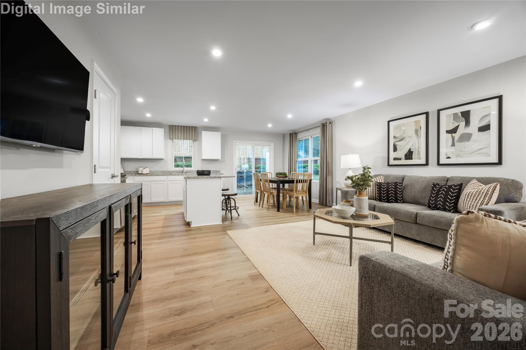 Open, inviting, and effortlessly connected—this Great Room blends kitchen, dining, and living spaces for seamless everyday comfort and entertaining. - 5215 Macvittie Lane, Charlotte