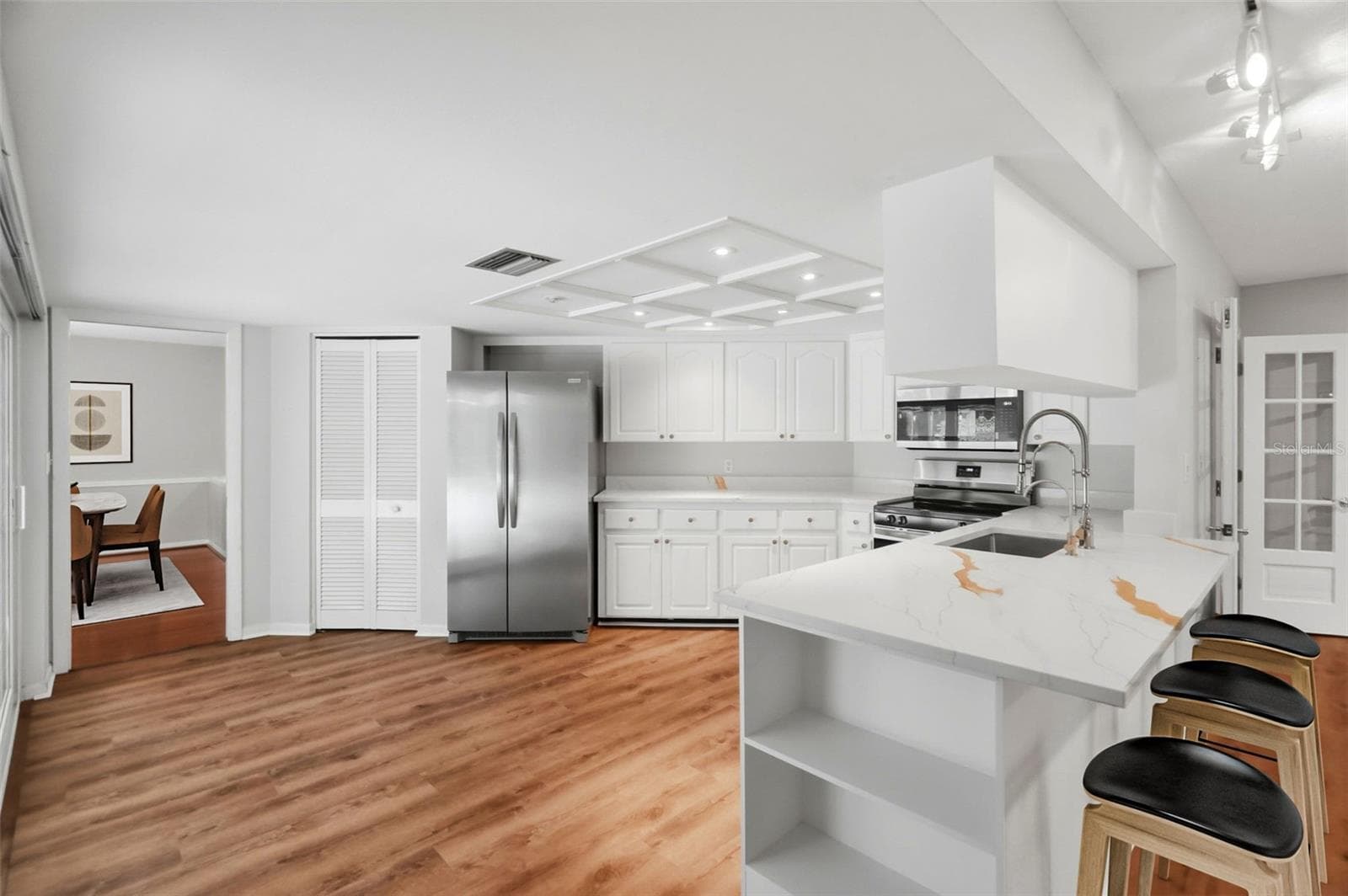 Anchoring the space is a centrally located kitchen. - 1297 PEACH TREE DR, DUNEDIN