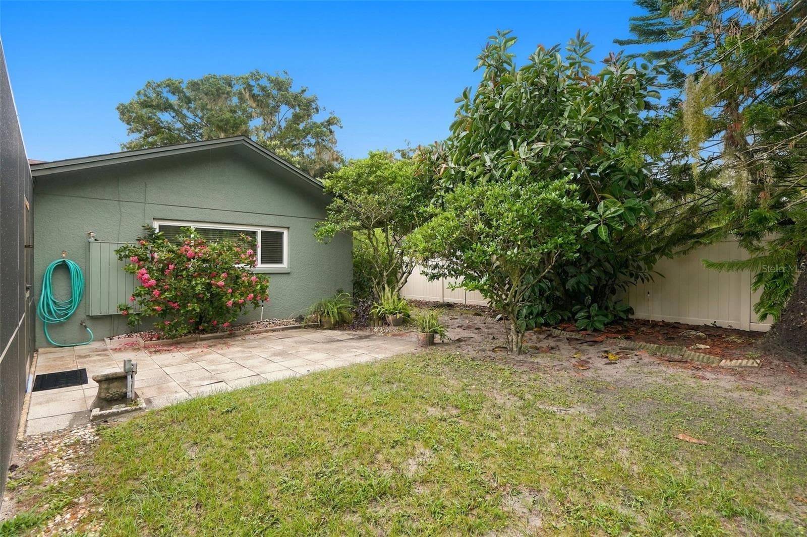 Maintained tropical landscaping. - 1297 PEACH TREE DR, DUNEDIN