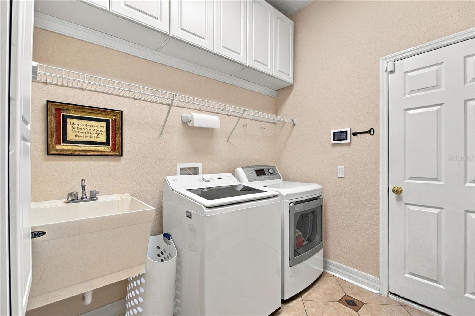 Inside laundry room with laundry sink.  Door leads out to the garage. - 4108 N FORBES RD, PLANT CITY