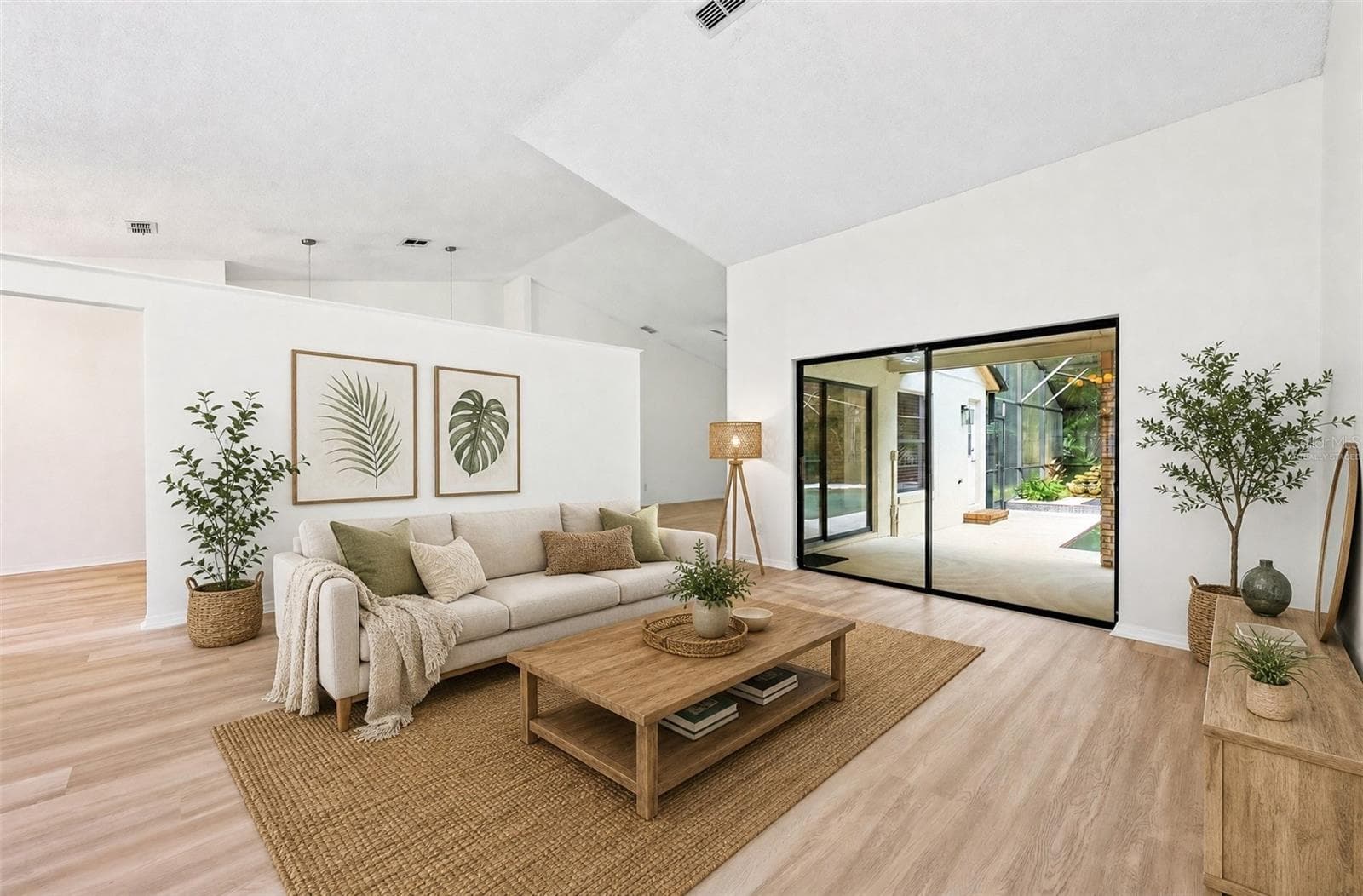 In the Living Room, sliding glass doors open to the PATIO AND POOL AREA—perfect for entertaining or enjoying a relaxed evening at home. Virtually Staged - 1003 N MAGEE CREEK CT, OVIEDO