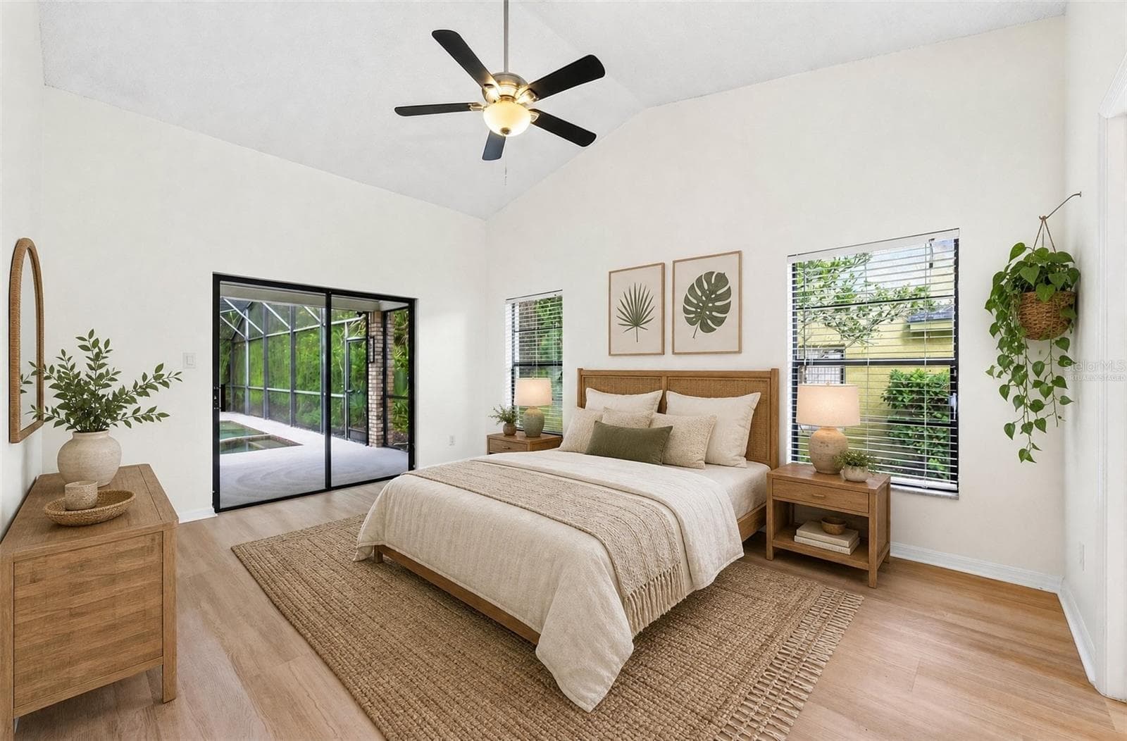 The spacious Primary Suite is filled with NATURAL LIGHT and features sliding glass doors that open directly to the pool and patio. Virtually Staged - 1003 N MAGEE CREEK CT, OVIEDO