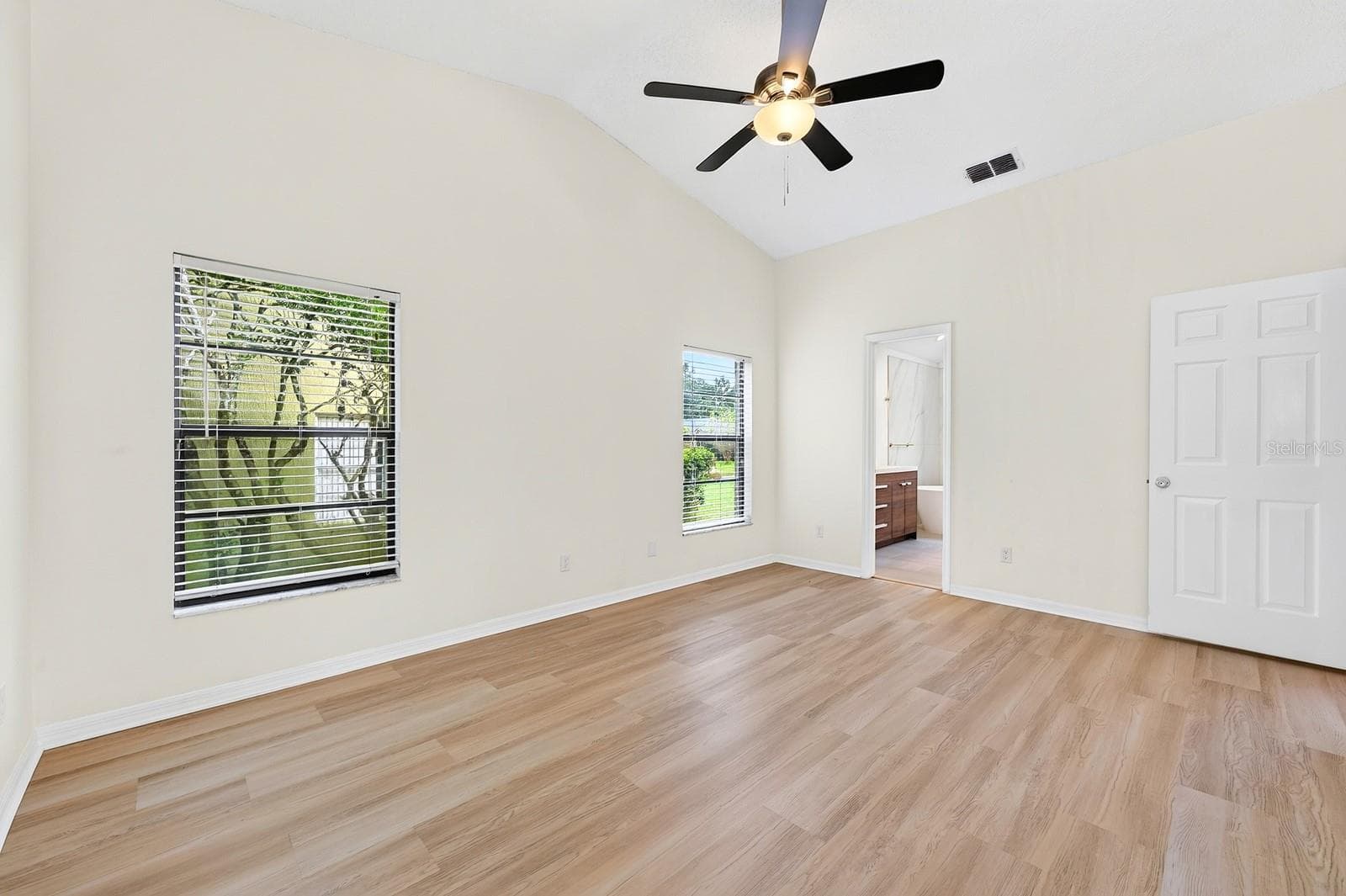 The spacious Primary Suite is filled with NATURAL LIGHT and features sliding glass doors that open directly to the pool and patio. - 1003 N MAGEE CREEK CT, OVIEDO