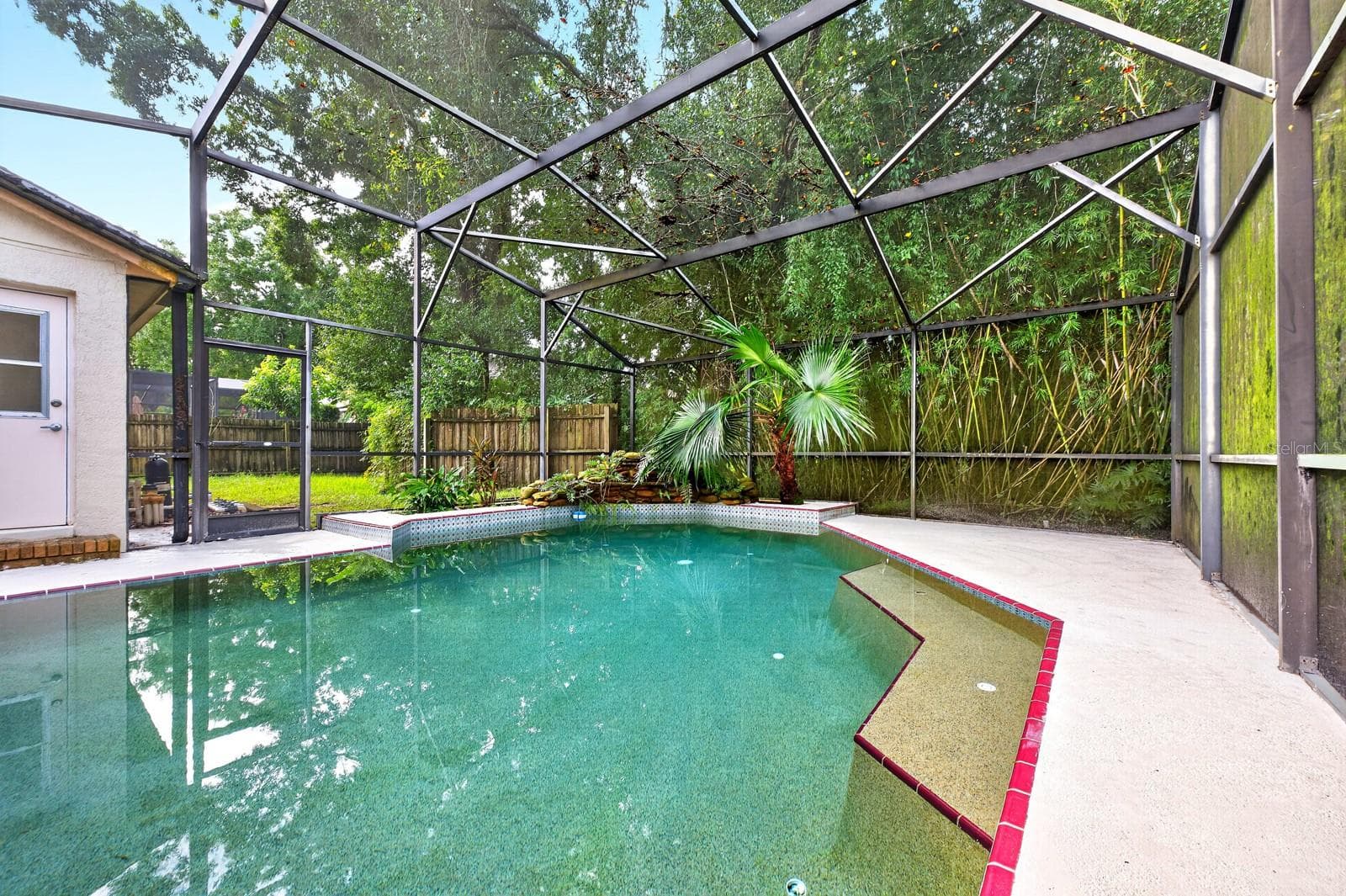 The in-ground pool and screened lanai create the perfect setting for swimming, relaxing and entertaining year-round. - 1003 N MAGEE CREEK CT, OVIEDO