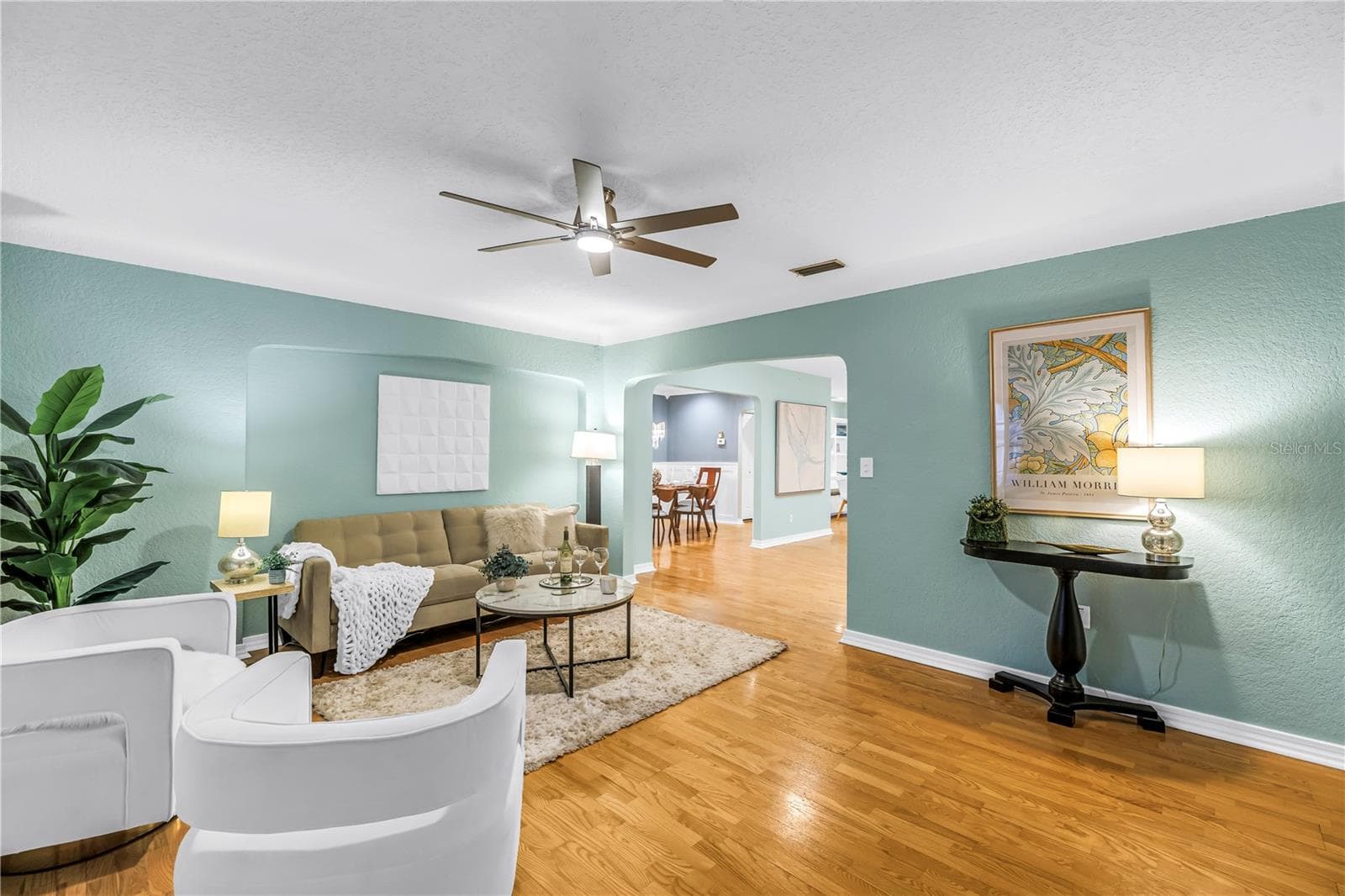 Formal living room with elegant crown molding, modern paint, updated fixtures, and an open layout in an exceptionally well-maintained home. - 146 GIRALDA BLVD NE, ST PETERSBURG