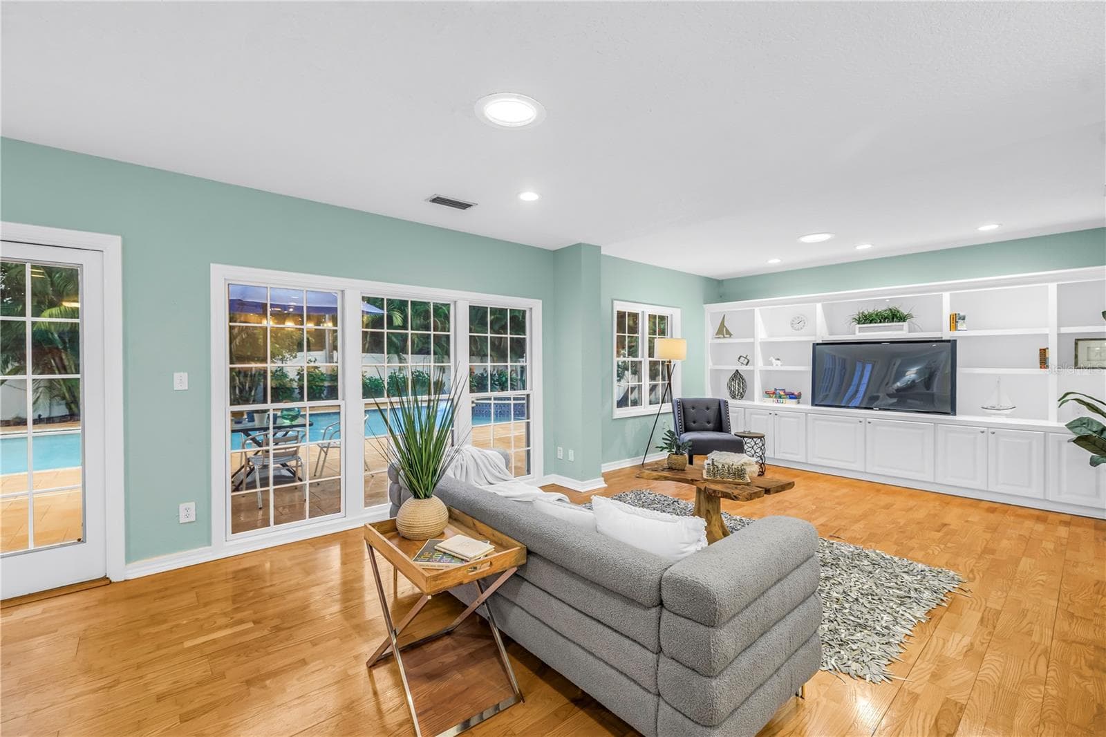 Spacious, casual living area adjacent to the kitchen, featuring direct views of the heated pool—an ideal setting for entertaining and watching the game with convenient access for a halftime swim. - 146 GIRALDA BLVD NE, ST PETERSBURG