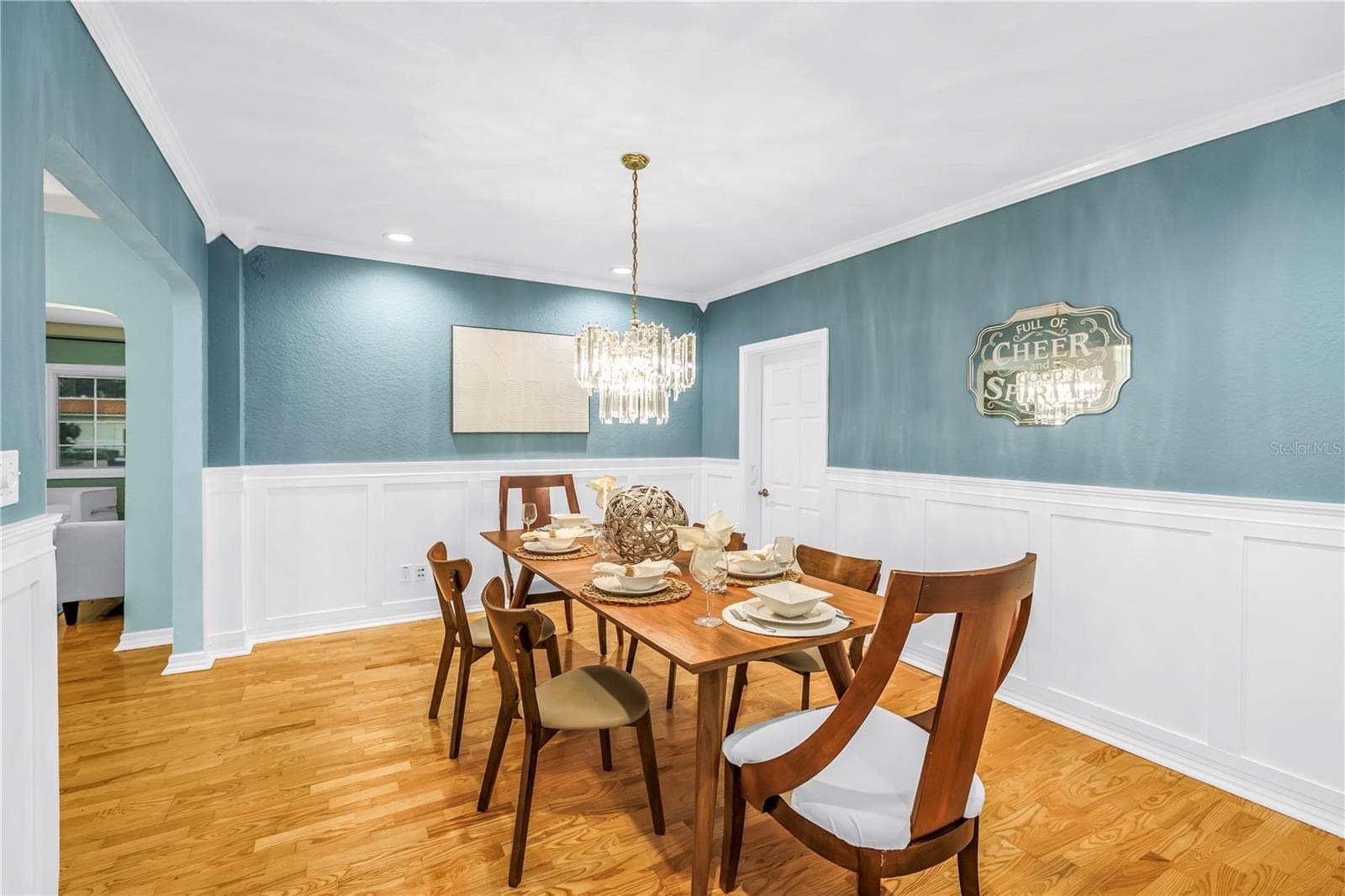 Hand-crafted wainscoting and crown molding elevate this spacious, accommodating formal dining room—perfect for hosting holiday gatherings. - 146 GIRALDA BLVD NE, ST PETERSBURG