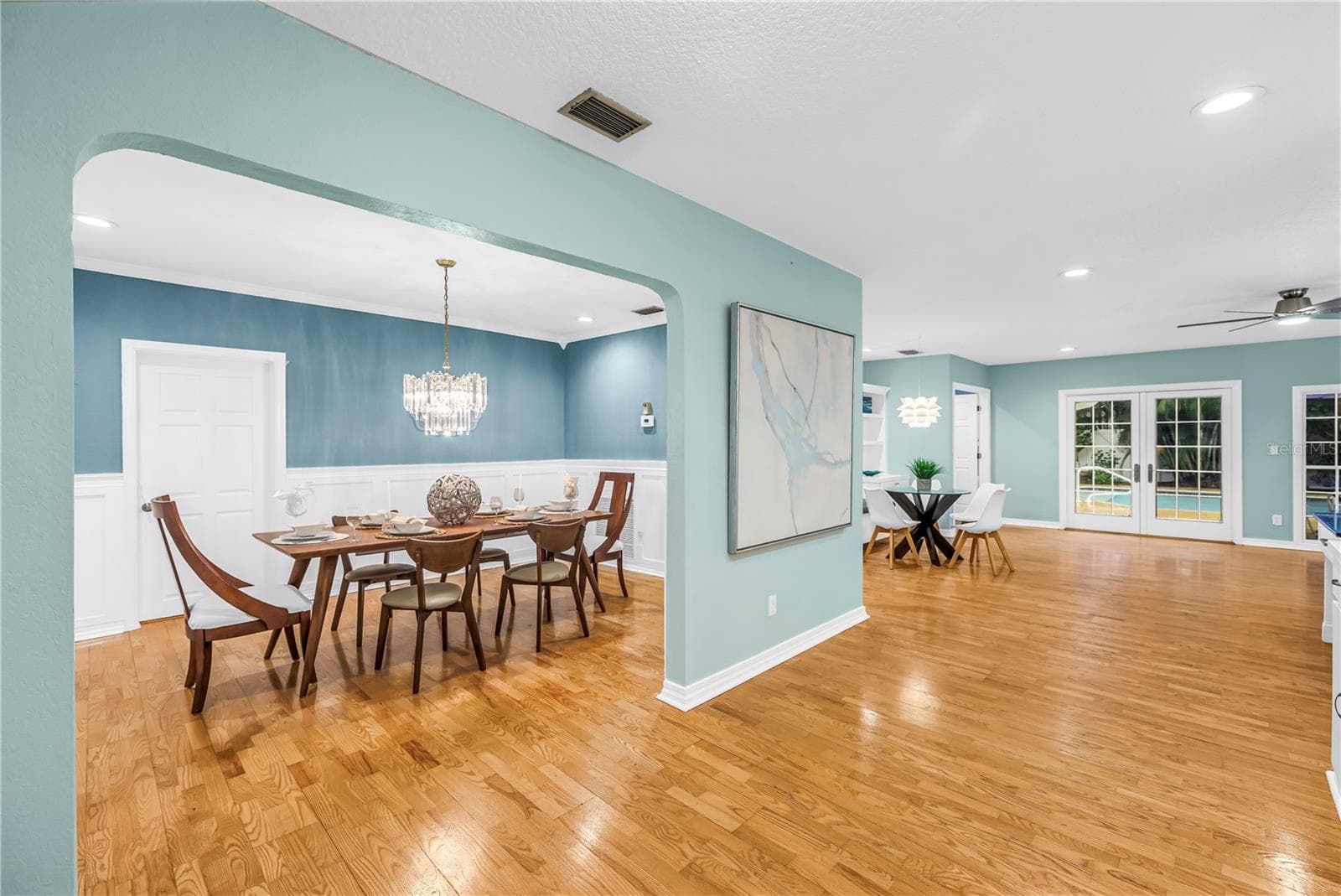 This open-concept dining area flows seamlessly into the surrounding living spaces, perfect for more social gathering - 146 GIRALDA BLVD NE, ST PETERSBURG
