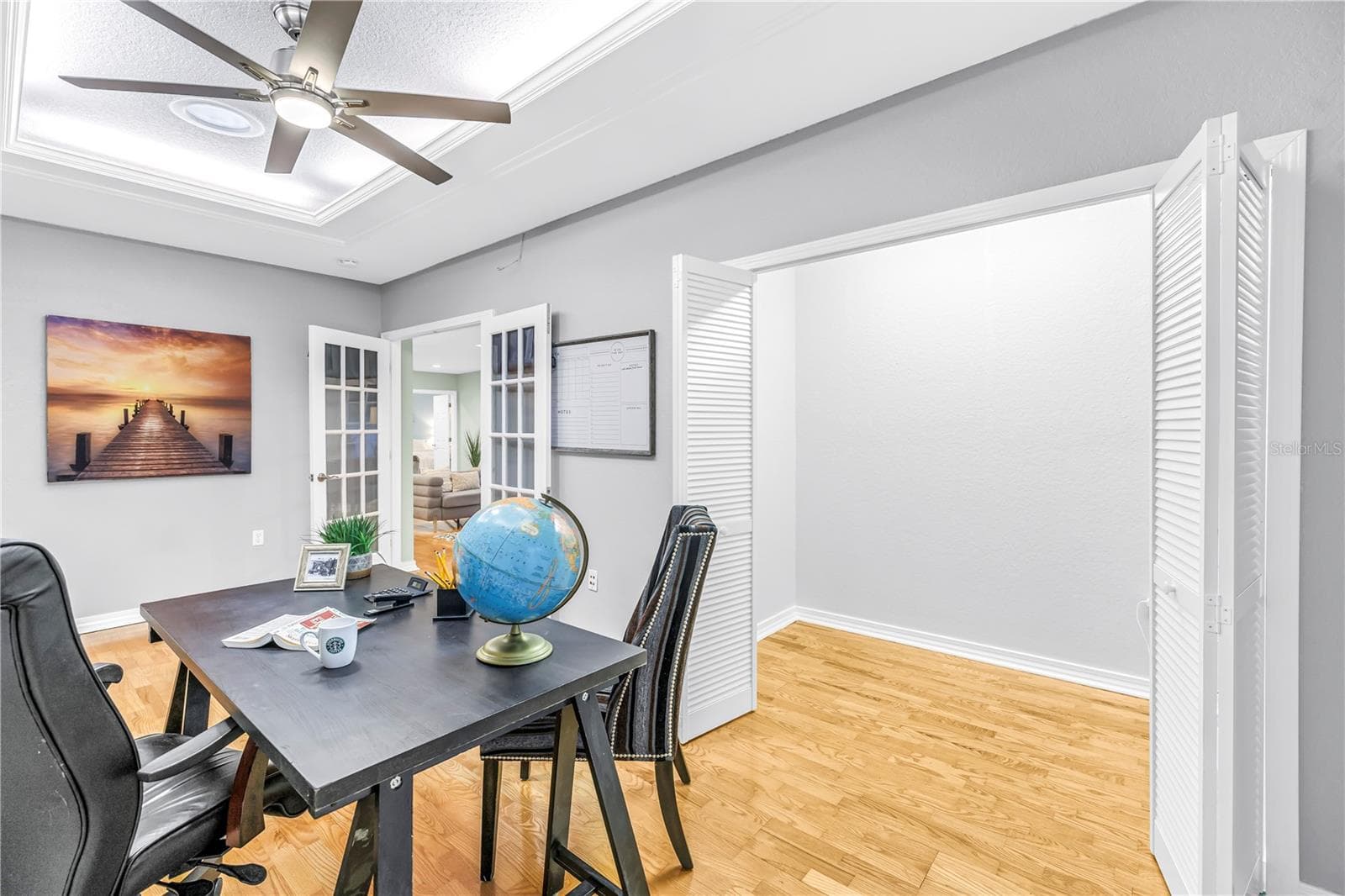 The fourth bedroom is currently utilized as an executive office, featuring a tray ceiling and an oversized closet. - 146 GIRALDA BLVD NE, ST PETERSBURG