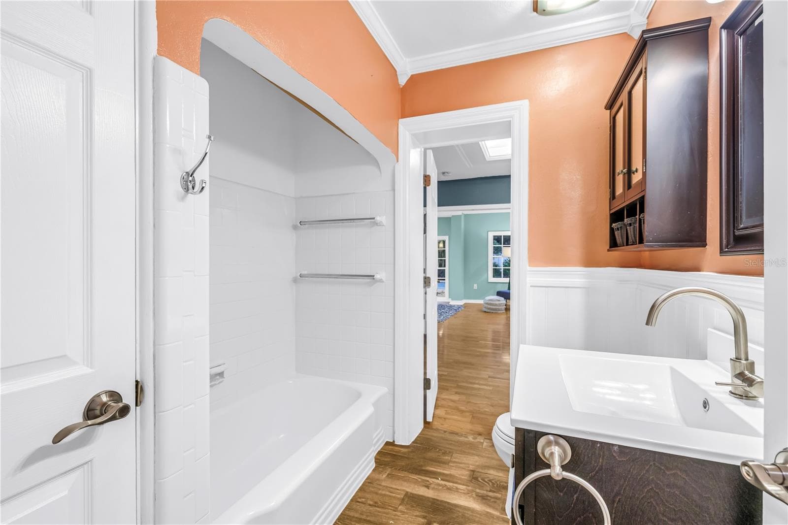 The Jack and Jill bathroom features a recently refinished shower, a modern updated vanity, and a convenient linen closet. - 146 GIRALDA BLVD NE, ST PETERSBURG
