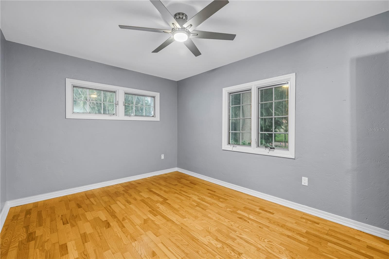 Spacious second bedroom with energy-efficient dual-pane windows, natural light, noise reduction, private half bathroom, and an expansive walk-in closet. - 146 GIRALDA BLVD NE, ST PETERSBURG