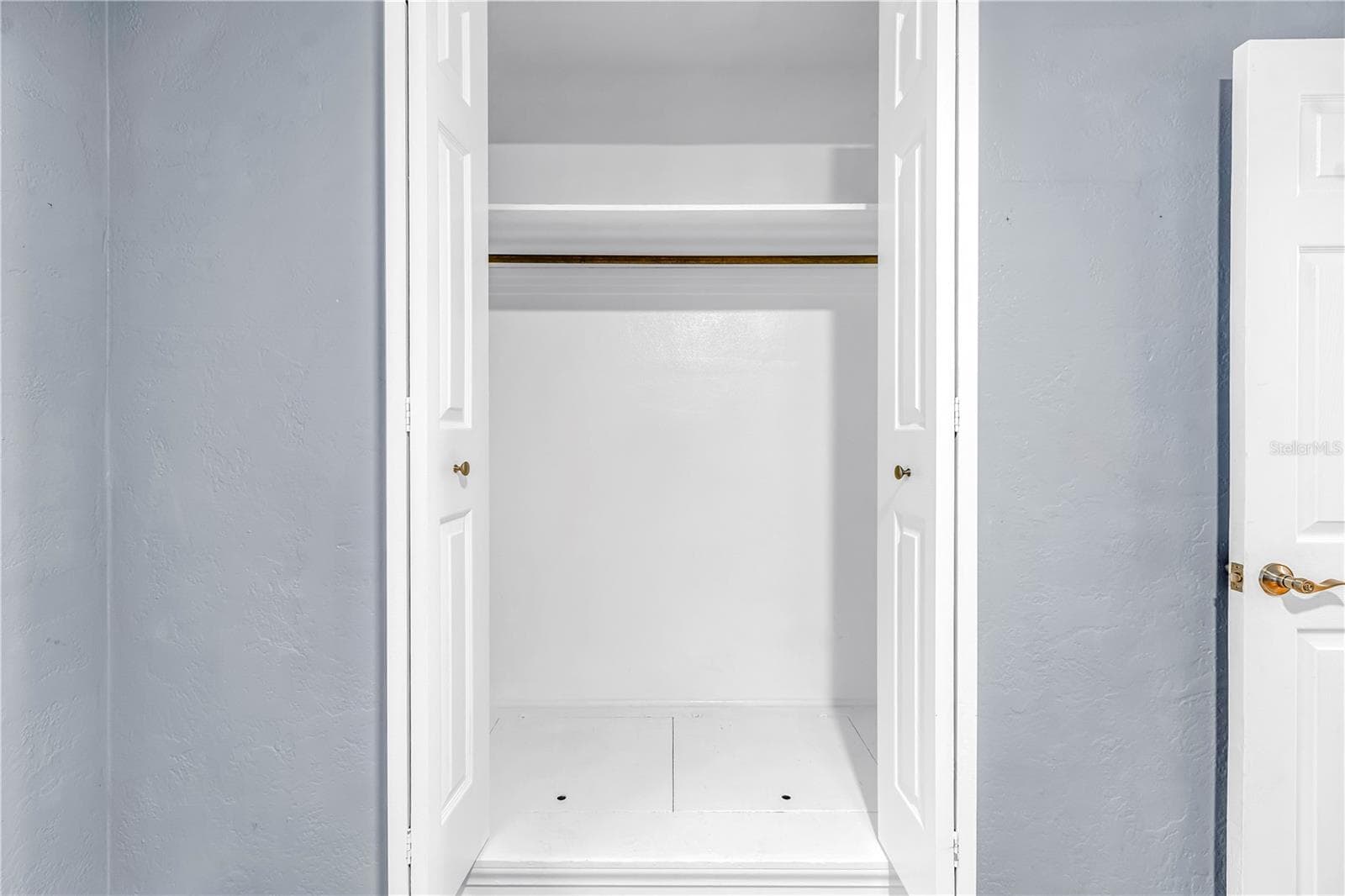 Third bedroom featuring a spacious closet with hidden floor-level storage. - 146 GIRALDA BLVD NE, ST PETERSBURG