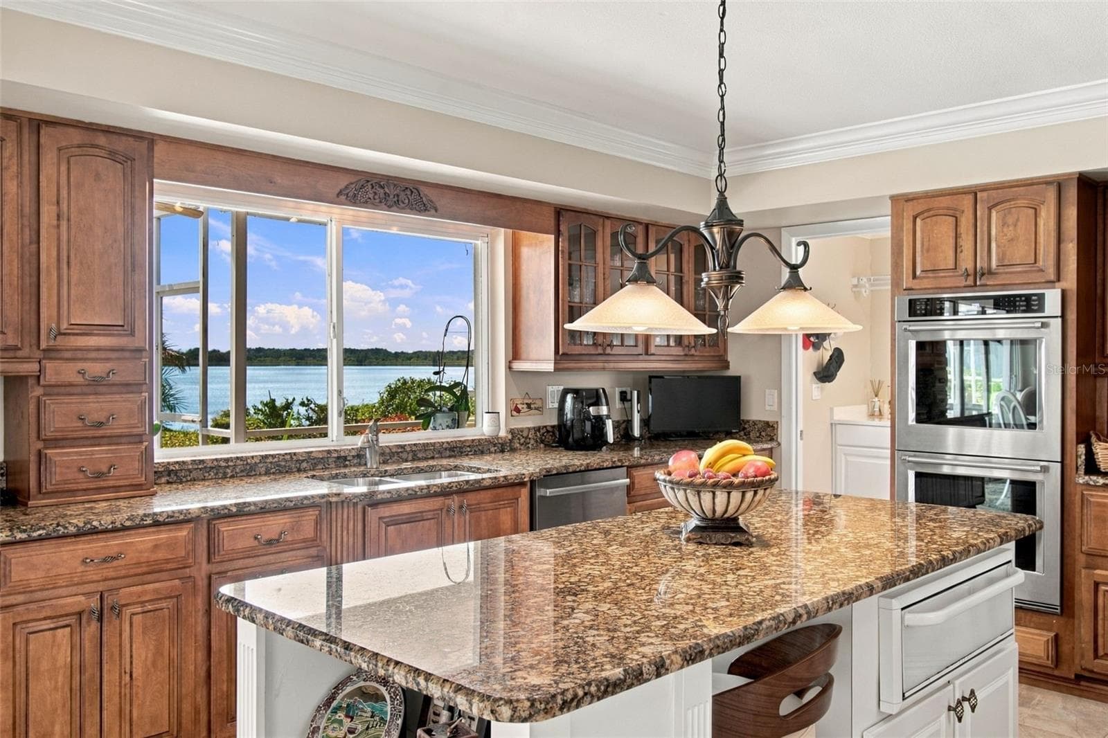 Lakeview kitchen - Pendant lighting & pass through window to outside bar - 1921 MANOR CIR SE, WINTER HAVEN