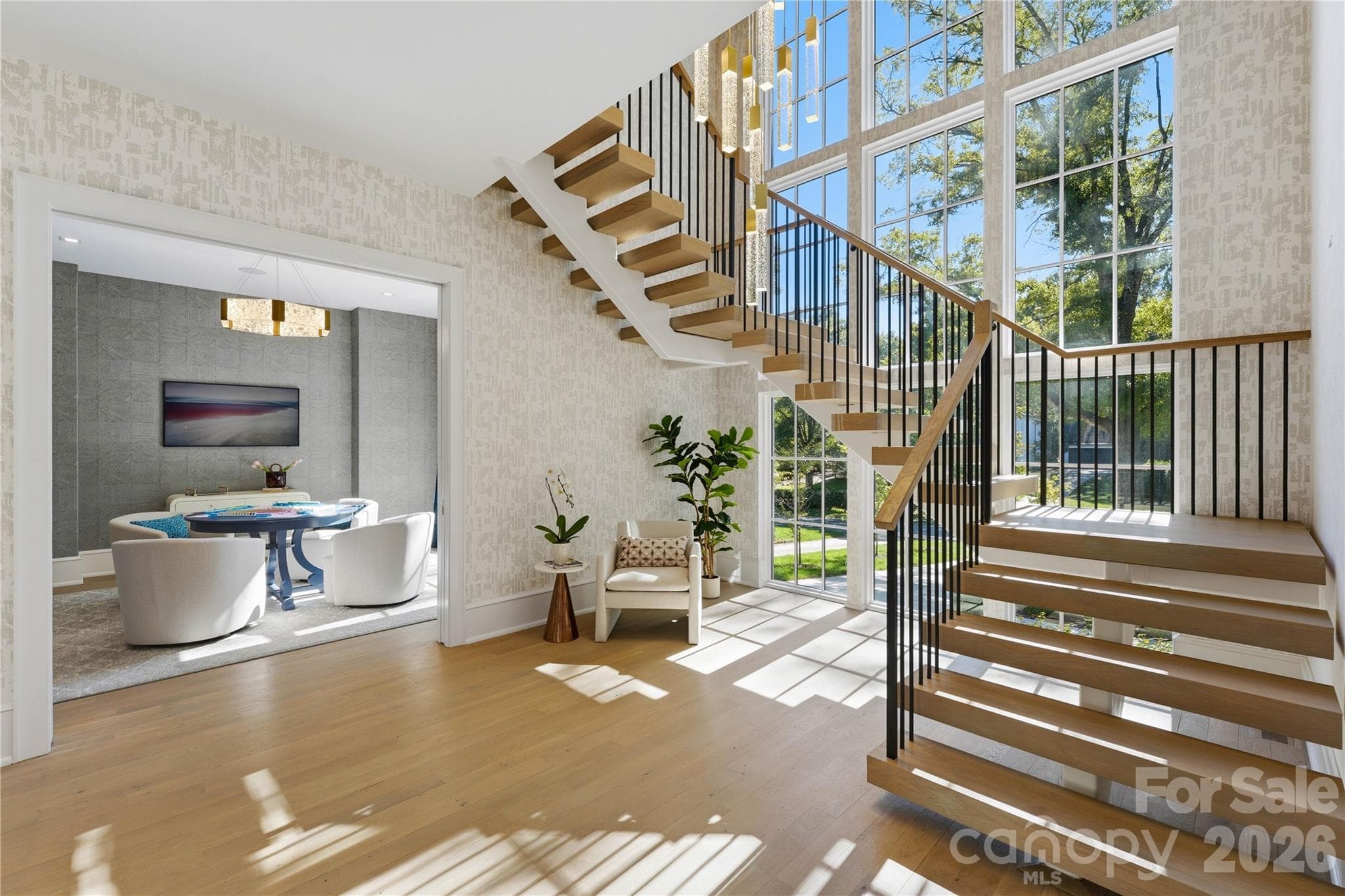 Dramatic floating staircase with 2 story wall of windows for incredible natural light. - 2610 Sedley Road, Charlotte