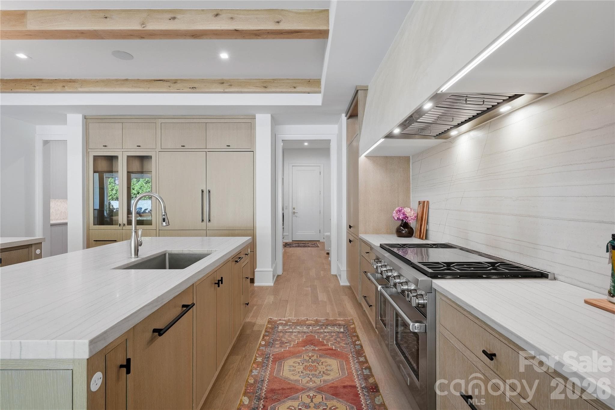 Kitchen features a 48" Wolf gas range and honed quartzite countertops. - 2610 Sedley Road, Charlotte