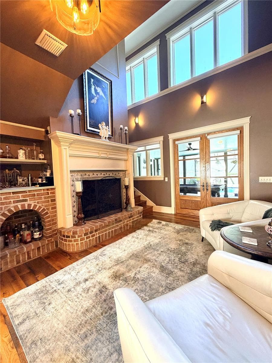 fireplace sitting room opens to the pool area - 5903 RIVER FOREST CIR, BRADENTON