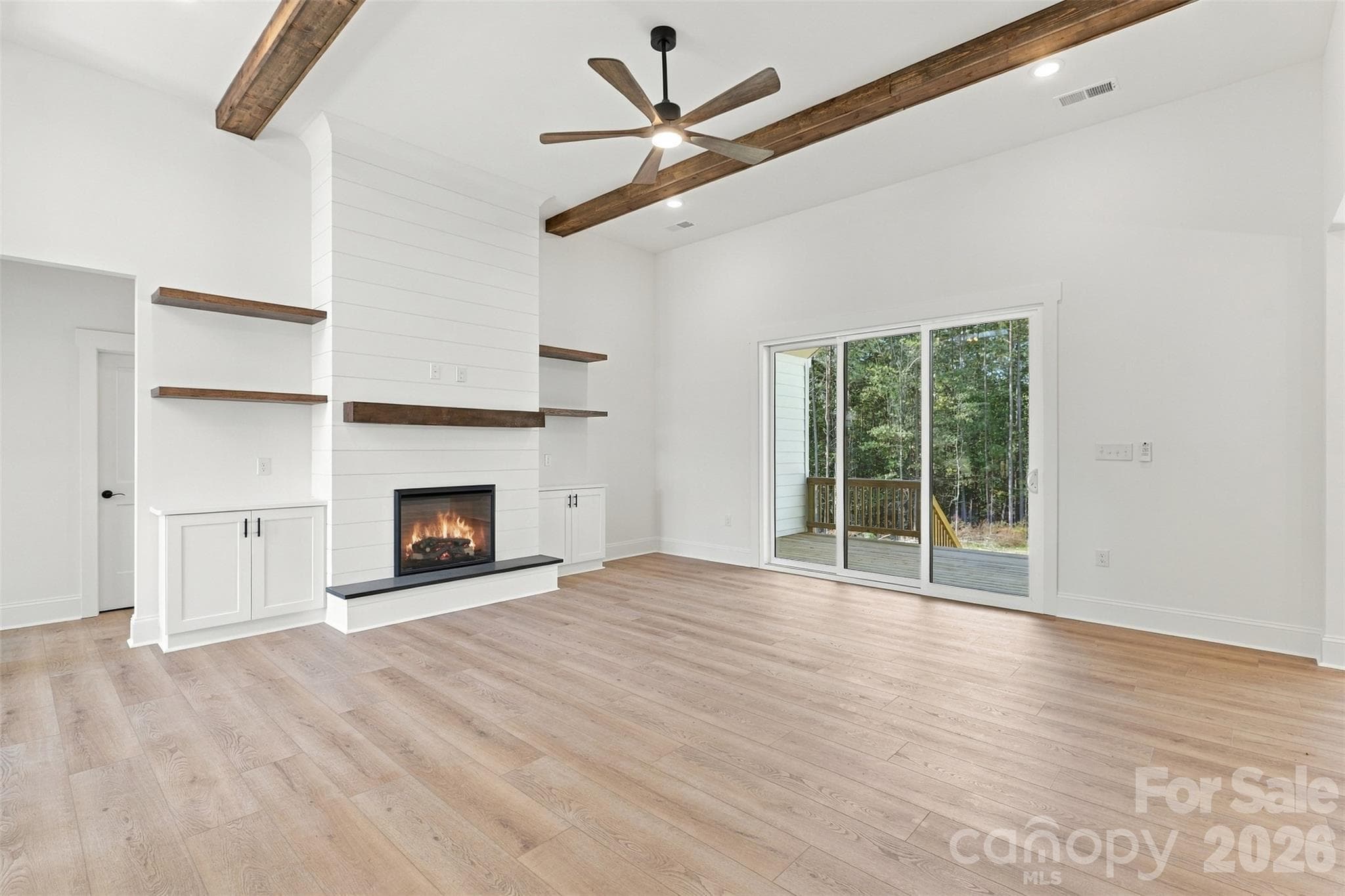 Living room- 12 ft ceilings, stained beams, electric shiplap fireplace, built-ins - 394 S NC 200 Highway, Stanfield
