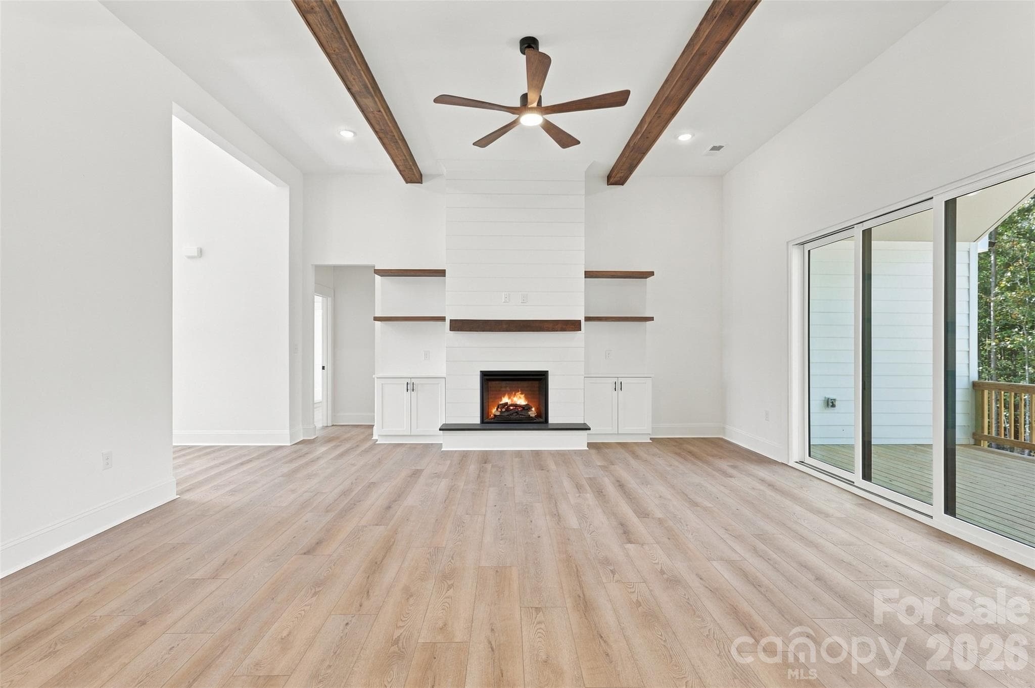 Living room- 12 ft ceilings, stained beams, electric shiplap fireplace, built-ins - 394 S NC 200 Highway, Stanfield