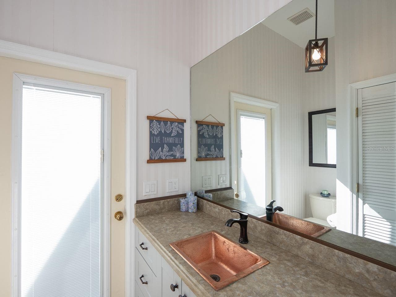 1/2 bath adjacent to laundry room with door out to pool area - 71 CAYMAN ISLES BLVD, ENGLEWOOD