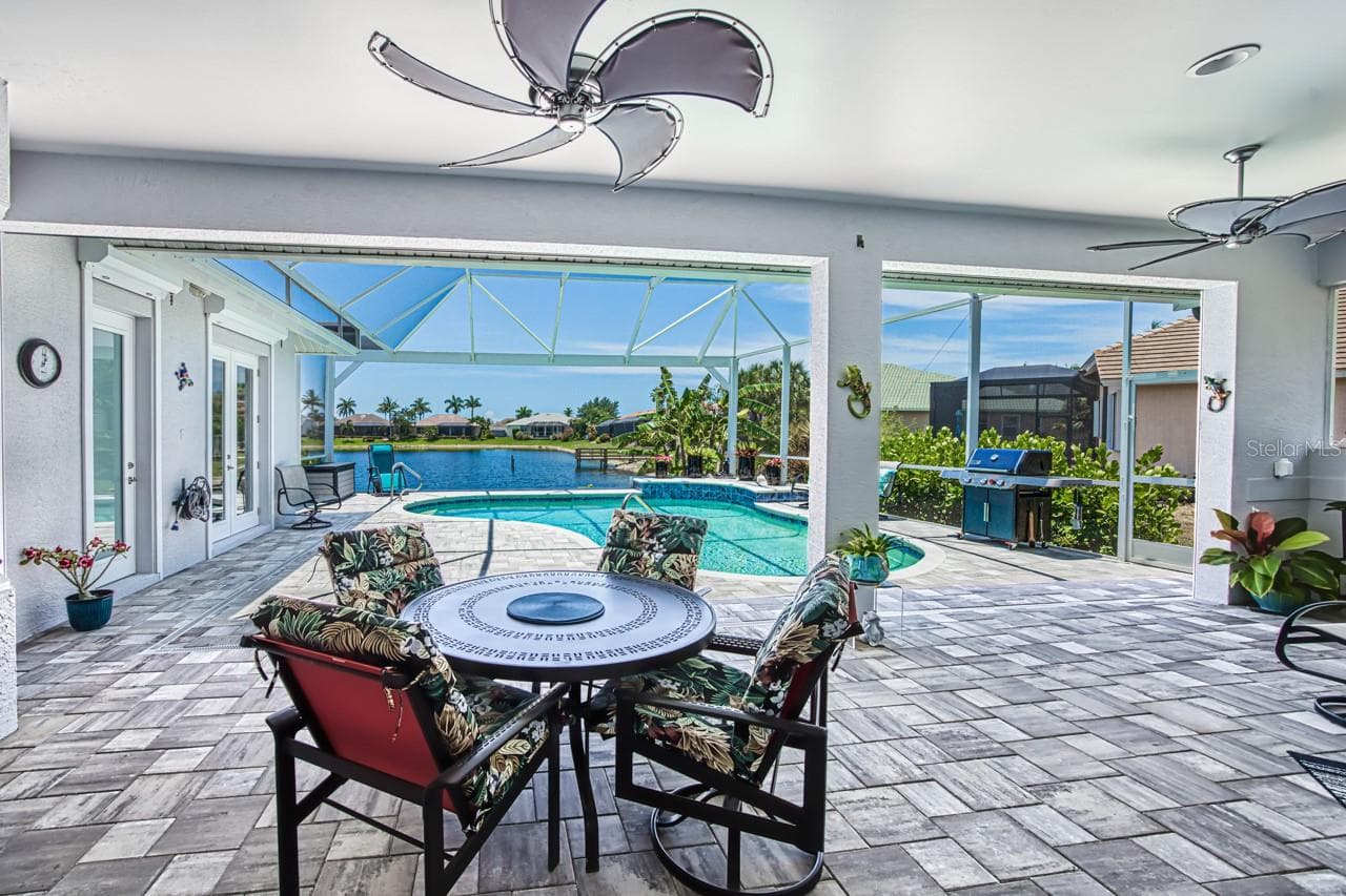 Lanai overlooking pool and lake - 8625 SOUTHWIND BAY CIR, FORT MYERS
