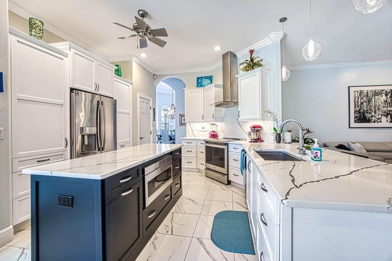 Custom cabinets with built in microwave.  Pull out drawers for easy access and tall Cabinets with pull out shelving - 8625 SOUTHWIND BAY CIR, FORT MYERS