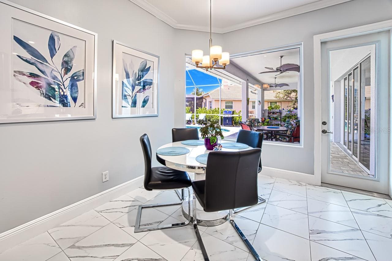 Dinette with pool view - 8625 SOUTHWIND BAY CIR, FORT MYERS