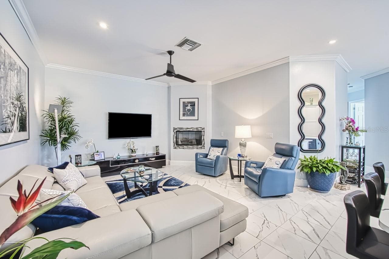 Family room with gas fireplace and recessed lighting - 8625 SOUTHWIND BAY CIR, FORT MYERS