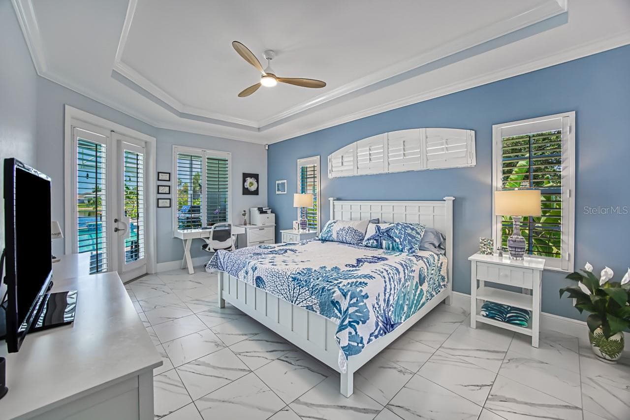 Primary Suite with French doors out to lanai/pool area - 8625 SOUTHWIND BAY CIR, FORT MYERS