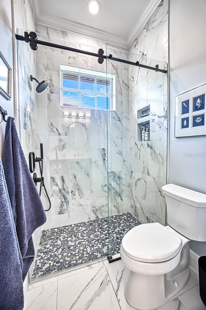 Shower with barn door glass doors - tiled walls - 8625 SOUTHWIND BAY CIR, FORT MYERS