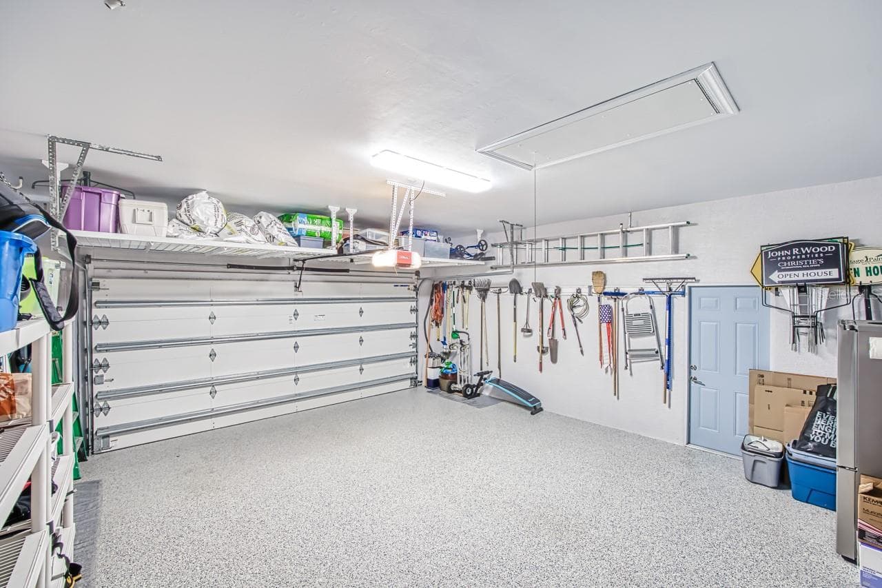 Overhead storage over garage door. - 8625 SOUTHWIND BAY CIR, FORT MYERS