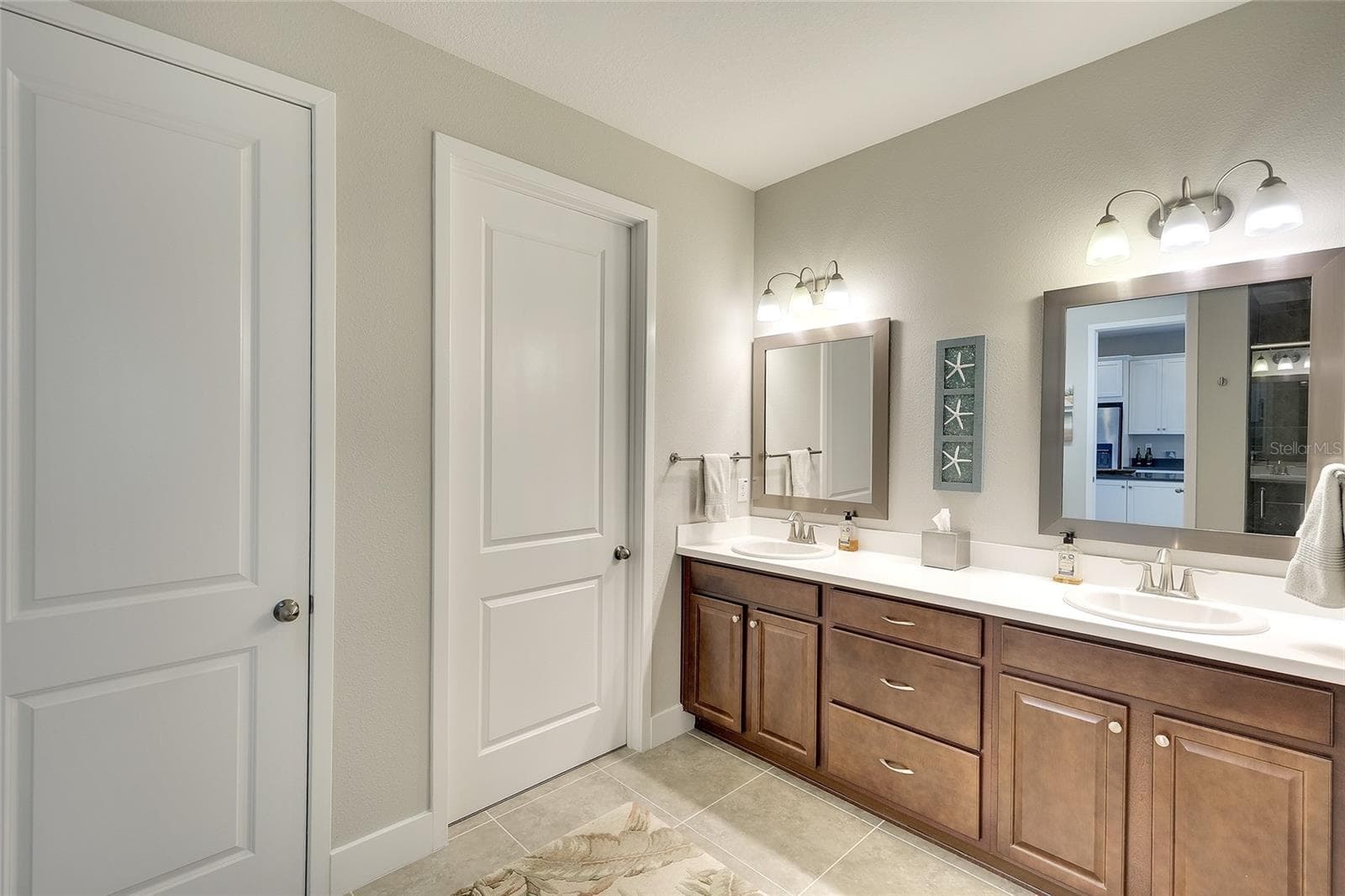 Owner's bath with double vanities, decorative lighting and accents, large walk in closet and OVERSIZED linen closet. - 5048 COURSE DR, SARASOTA