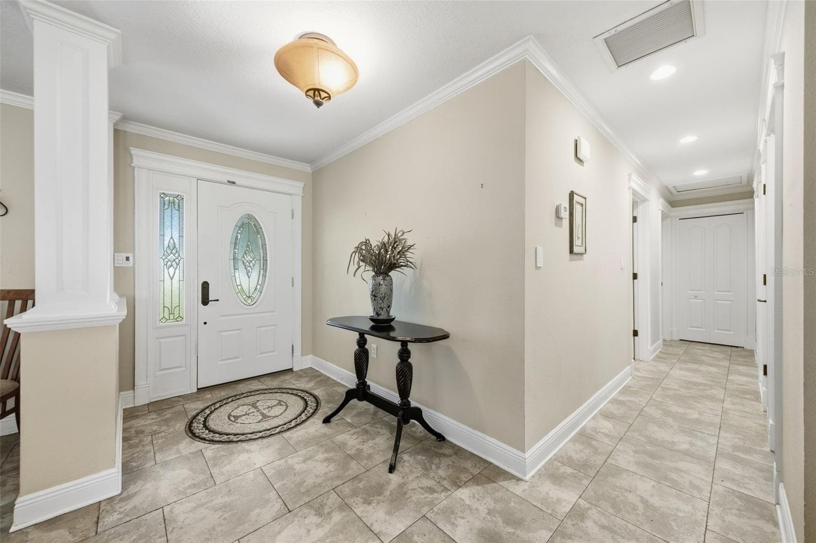 Hallway leads to 3 bedrooms and 2 baths.  Primary suite on opposite side of house. - 17501 LAKESHORE RD, LUTZ