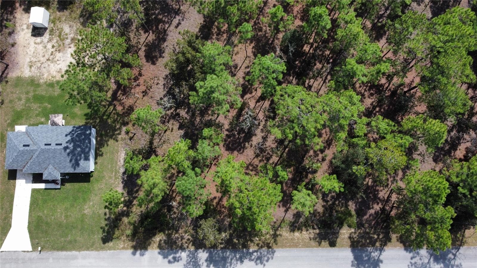 The subject lot is directly to the right of this home - TBD NW TAMARIND LN, DUNNELLON