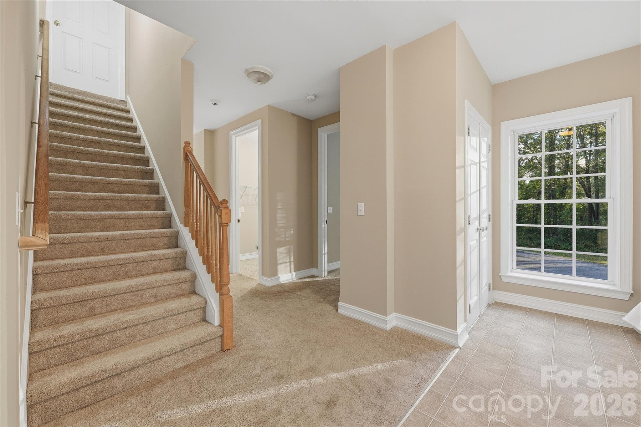 Stairs leading up to the unfinished second floor off of entry way with coat closet - 151 Robertson Drive, Taylorsville