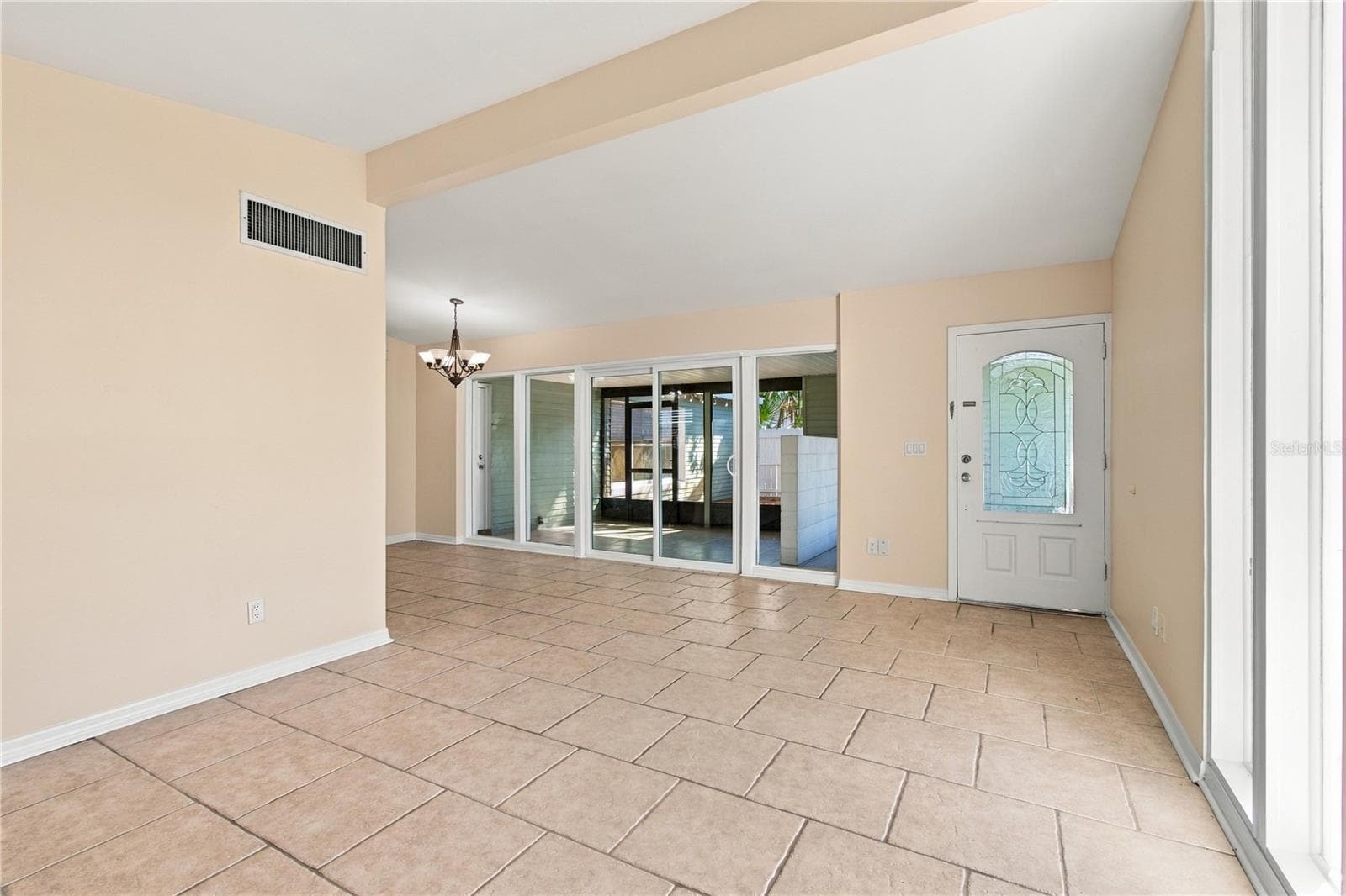 Living room overlooking entry and new sliding doors. - 10312 LAKE CARROLL WAY, TAMPA