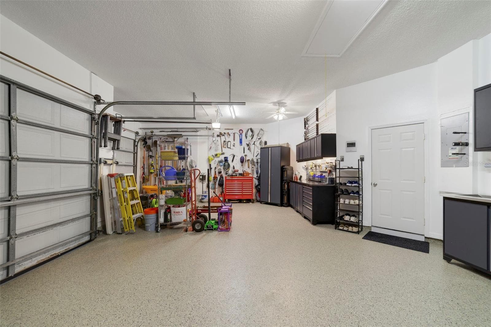 Immaculate garage with tech floor finish/S/S Cabinets, plenty of storage !! - 3514 OCITA DR, ORLANDO