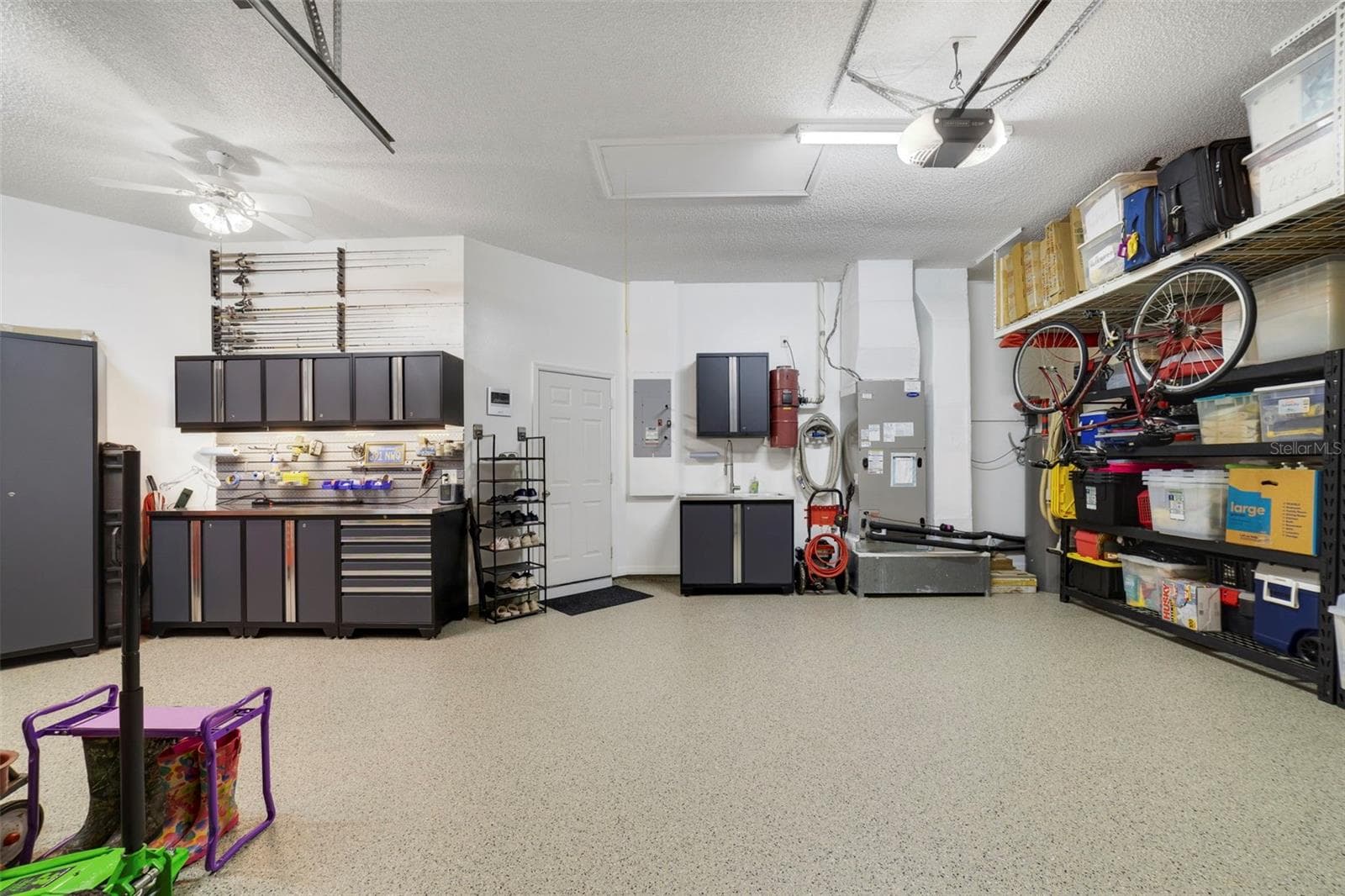 Another view of this magnificent garage space with custom workshop and storage shelves - 3514 OCITA DR, ORLANDO