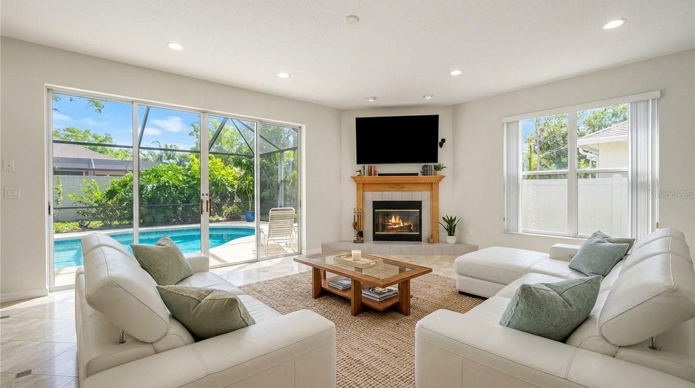 Spacious living room featuring an open-concept design with seamless entry access. - 7866 BARDMOOR HILL CIR, ORLANDO