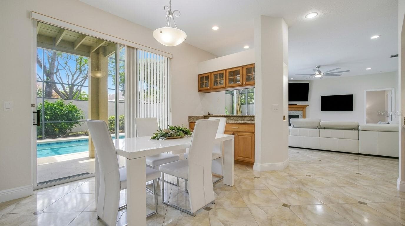 Sliding glass door leading to the pool area. - 7866 BARDMOOR HILL CIR, ORLANDO