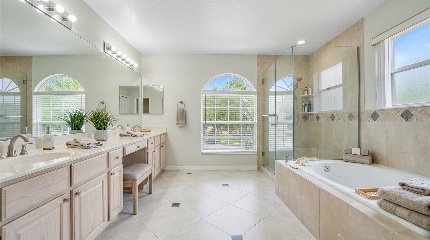 Master bathroom featuring a soaking tub. - 7866 BARDMOOR HILL CIR, ORLANDO
