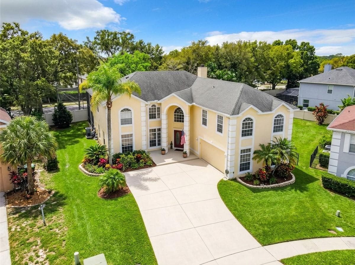 Aerial view of the property entrance and roofline. - 7866 BARDMOOR HILL CIR, ORLANDO