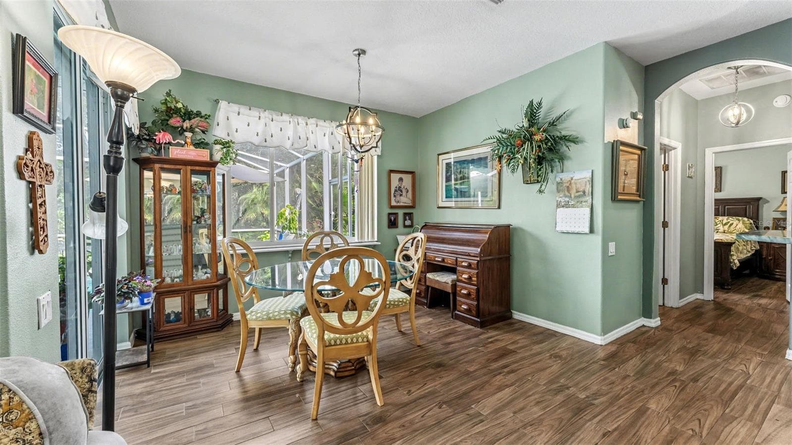 dinette just off the kitchen with picture window looking out to the pool and backyard - 6626 ROYAL FOREST DR, LAKELAND