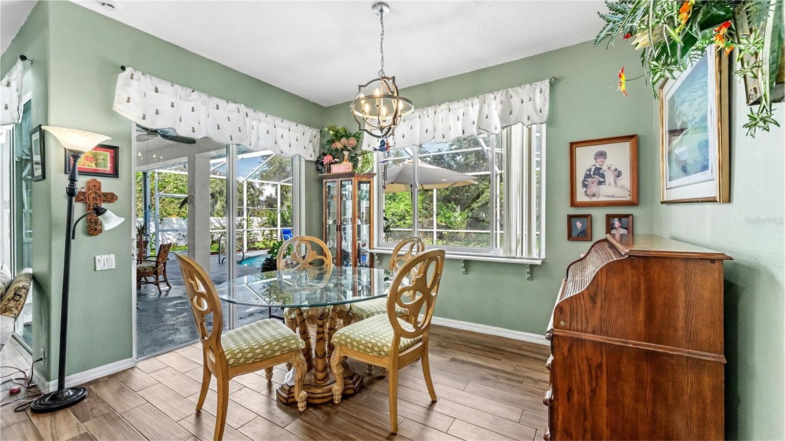 dinette just off the kitchen with picture window looking out to the pool and backyard - 6626 ROYAL FOREST DR, LAKELAND