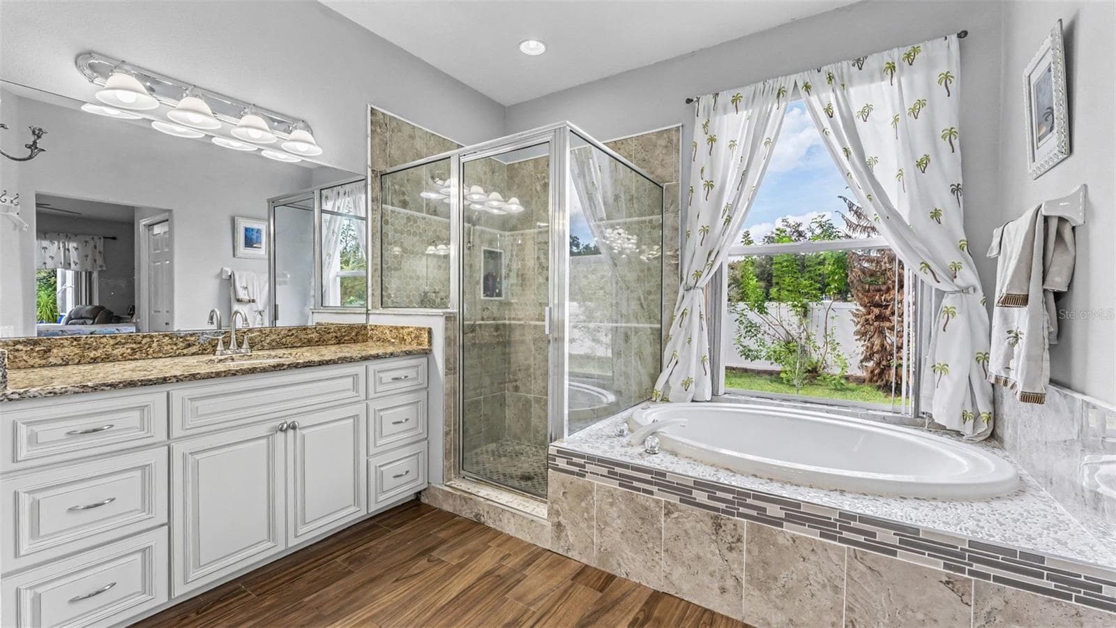 Beautiful remodeled ensuite bathroom with soaking tub, walk-in shower, double vanities, and private toilet room - 6626 ROYAL FOREST DR, LAKELAND