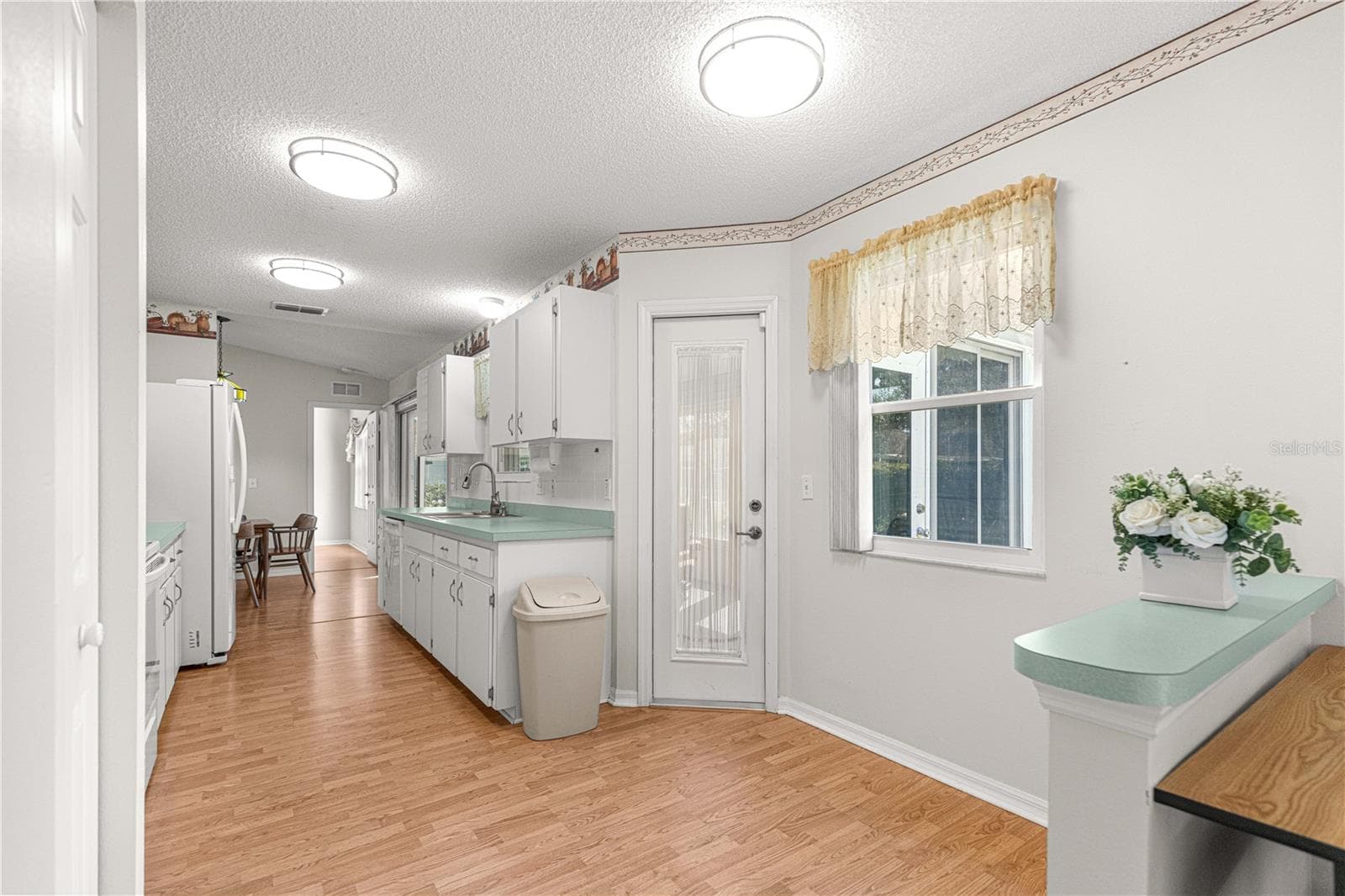 View looking back towards the kitchen showing access door to Encl Florida Room - 6164 SW 84 LN, OCALA