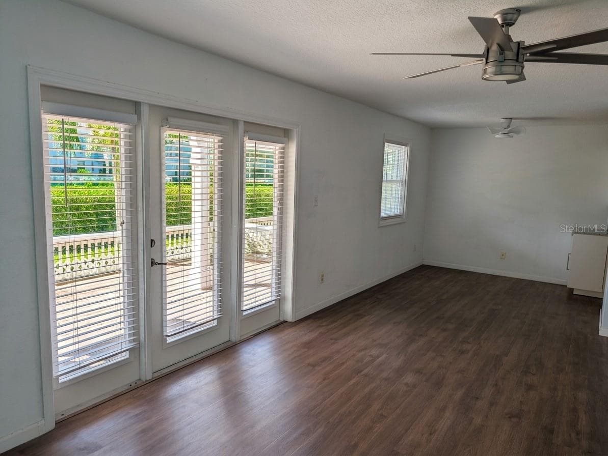 LIVING AREA WITH VIEW OUT TO THE PATIO - 4985 COBIA DR SE #B, ST PETERSBURG