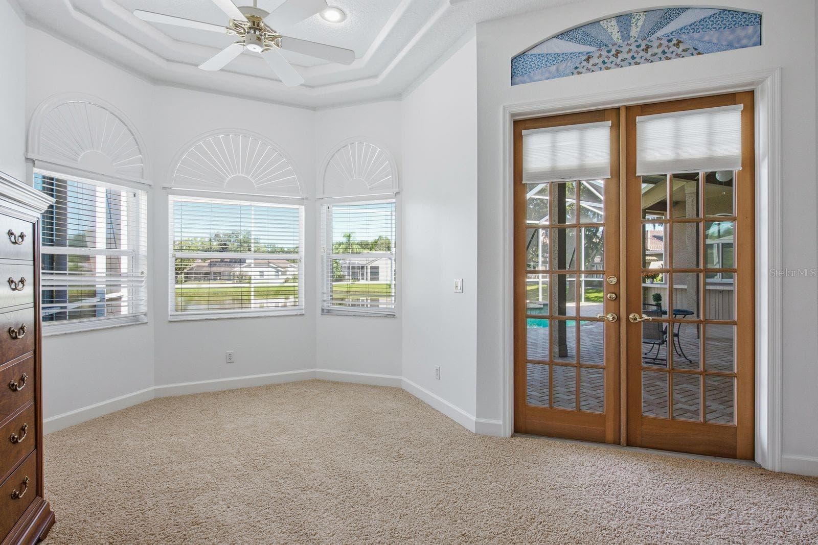 Large Sitting Area in the Primary Bedroom with Bay Window and French doors leading to the Lanai - 3763 EXECUTIVE DR, PALM HARBOR