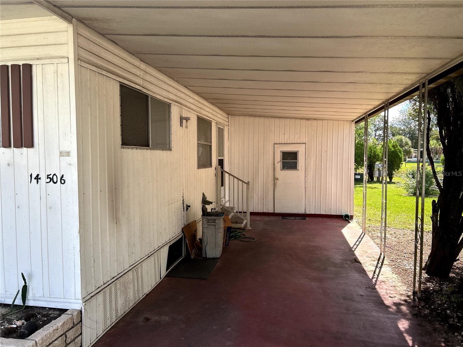 covered carport, utility room/ laundry room and entrance to kitchen. - 14506 DEHAVEN AVE, BROOKSVILLE