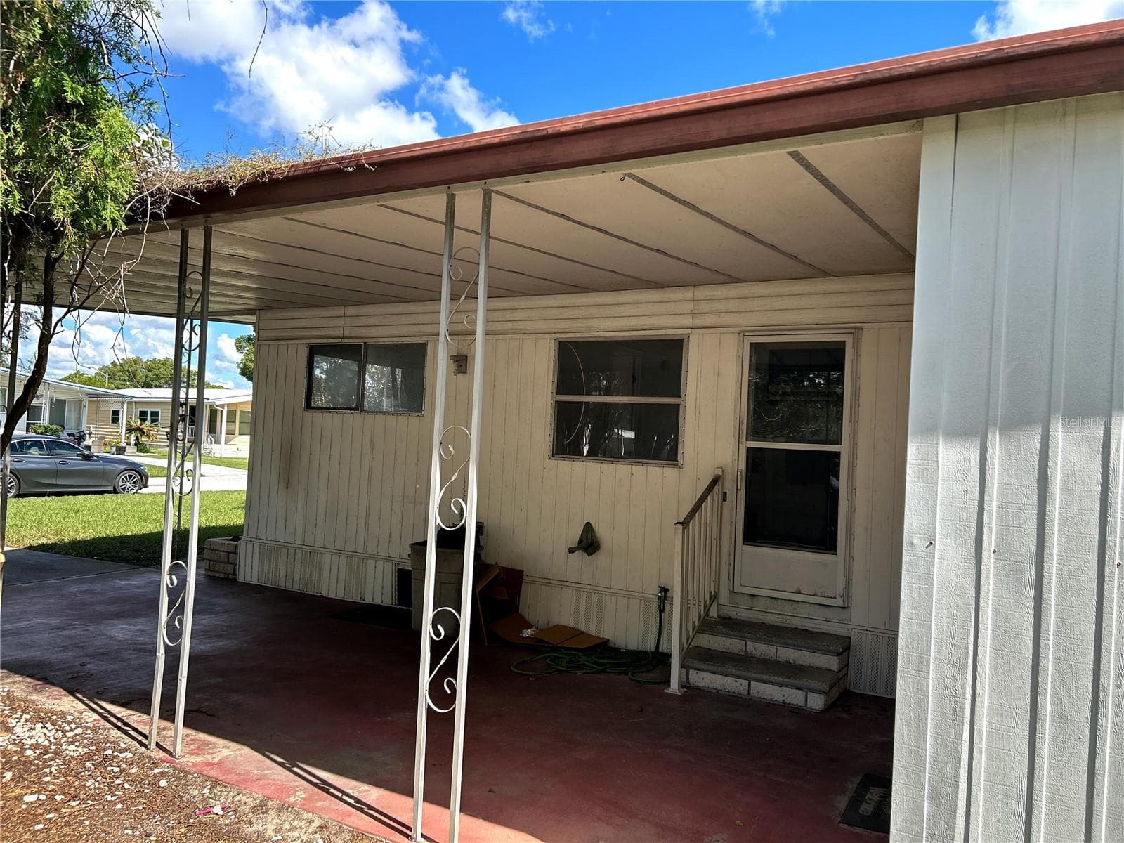 side view looking into carport and utility room/ laundry room with door to kitchen. - 14506 DEHAVEN AVE, BROOKSVILLE