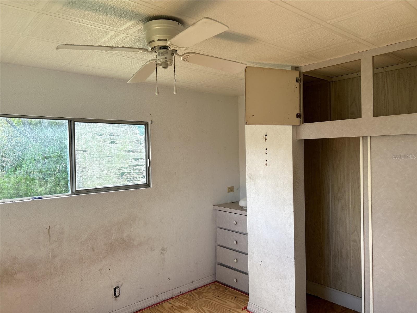 primary bedroom with built in closet and drawers at back of home. - 14506 DEHAVEN AVE, BROOKSVILLE